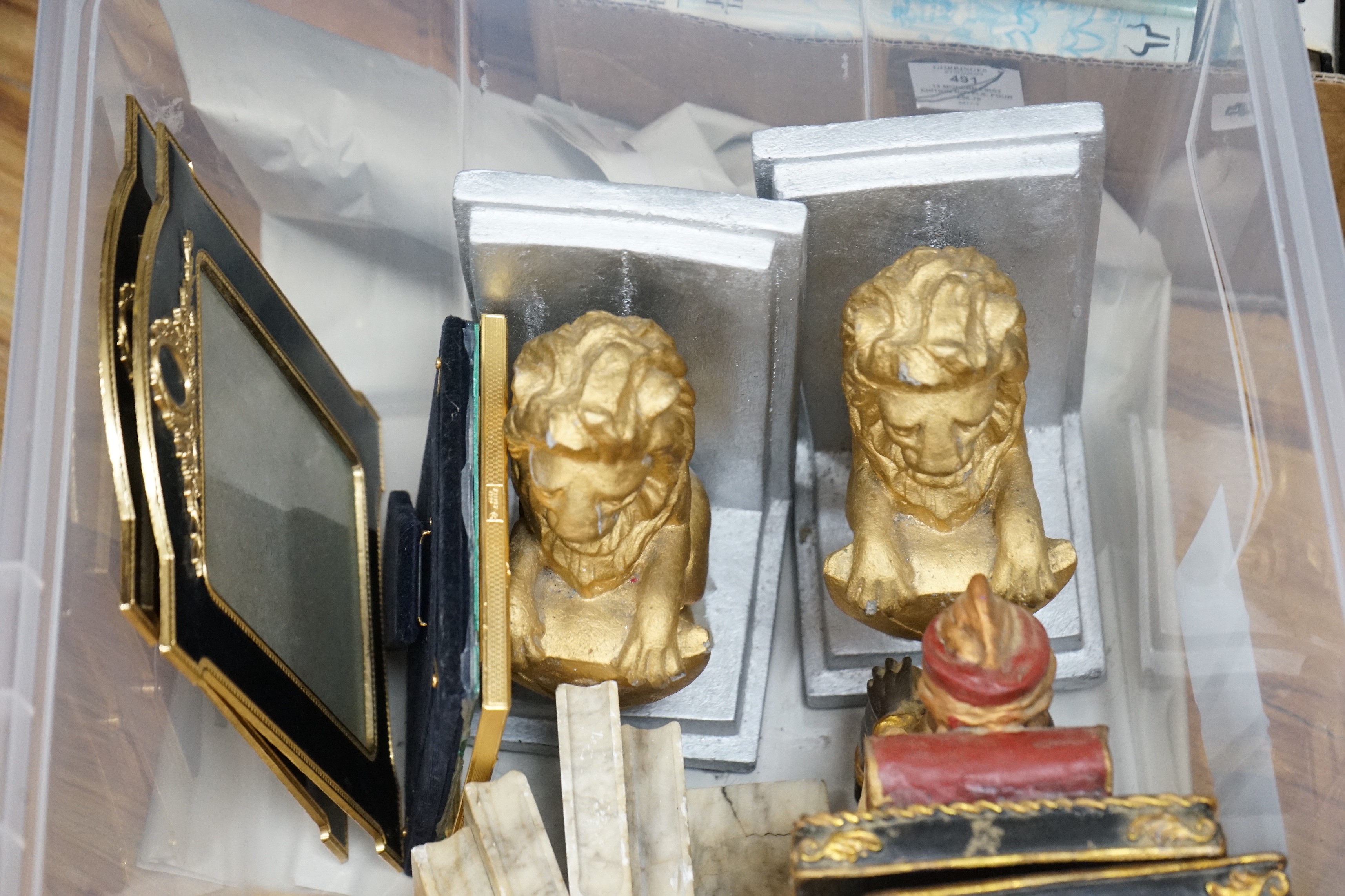 Various pairs of bookends and three photograph frames